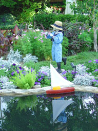 a child plays with a model sailsboat