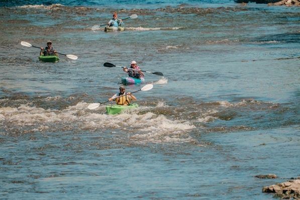 4 kayakers along a Milwaukee County Parks waterway