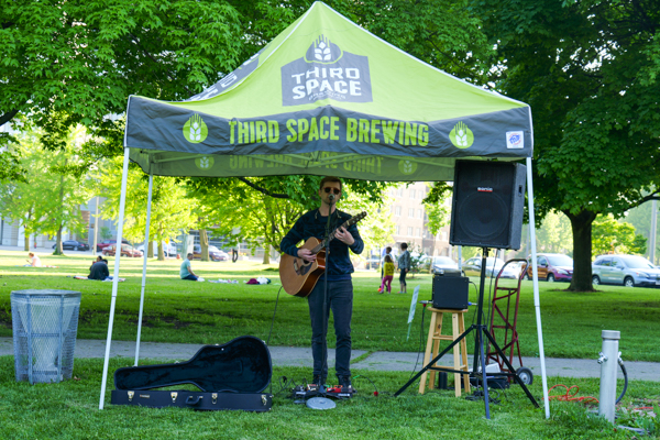 guitarist playing under a Third Space Brewing tent