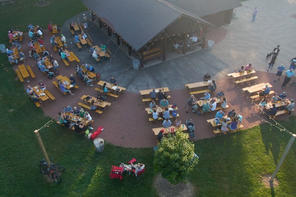 aerial photo of whitnall beer garden with picnic tables and awning lights