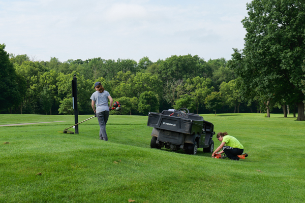 Crewmembers preparing a golf course