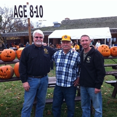 Hales Corners Lions: Jim Gilboy and Jerry Mudlaff survey pumpkin creations made by kids age 8-10 with Supervisor Taylor.