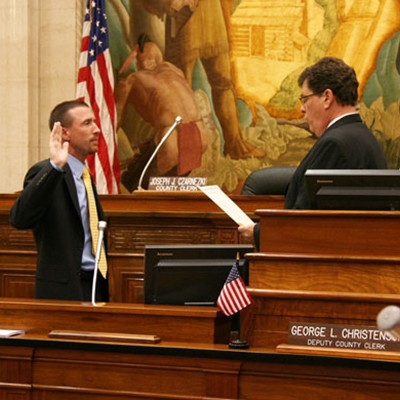 Supervisor Taylor taking his Oath of Office, administered by County Clerk Joe Czarnezki, on April 16, 2012 in the Milwaukee County Board Chambers.